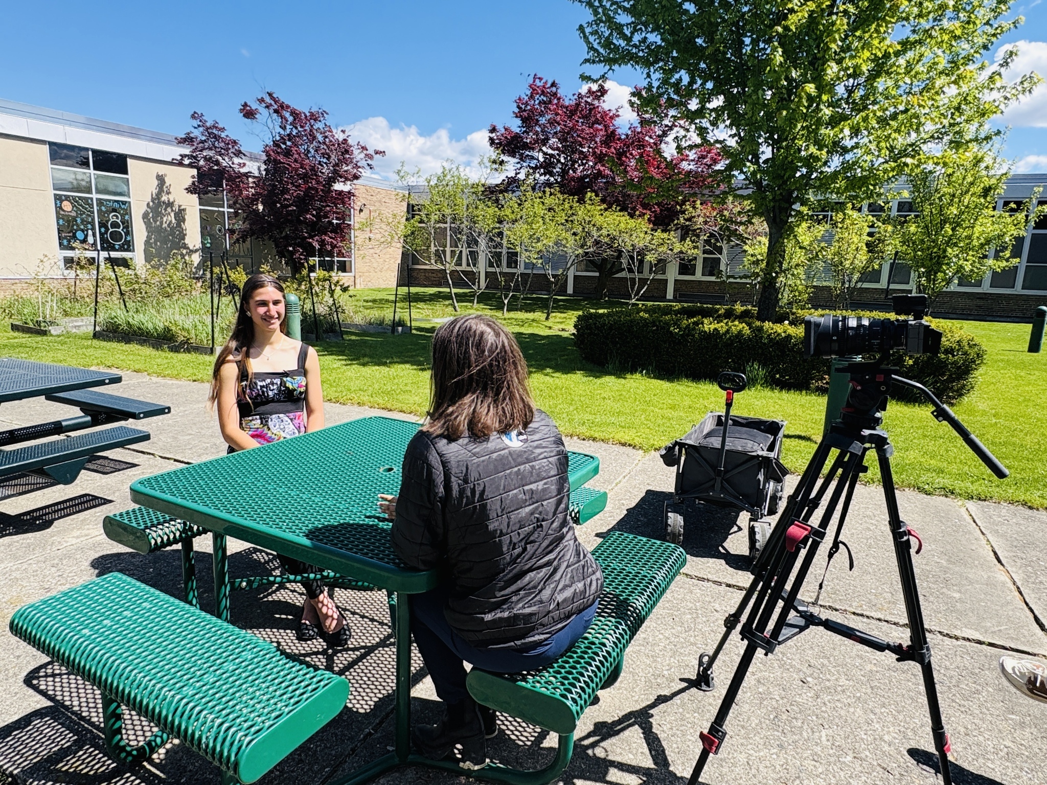 A student sits down at a picnic table in Kettering High School's courtyard to talk to Channel 7 news