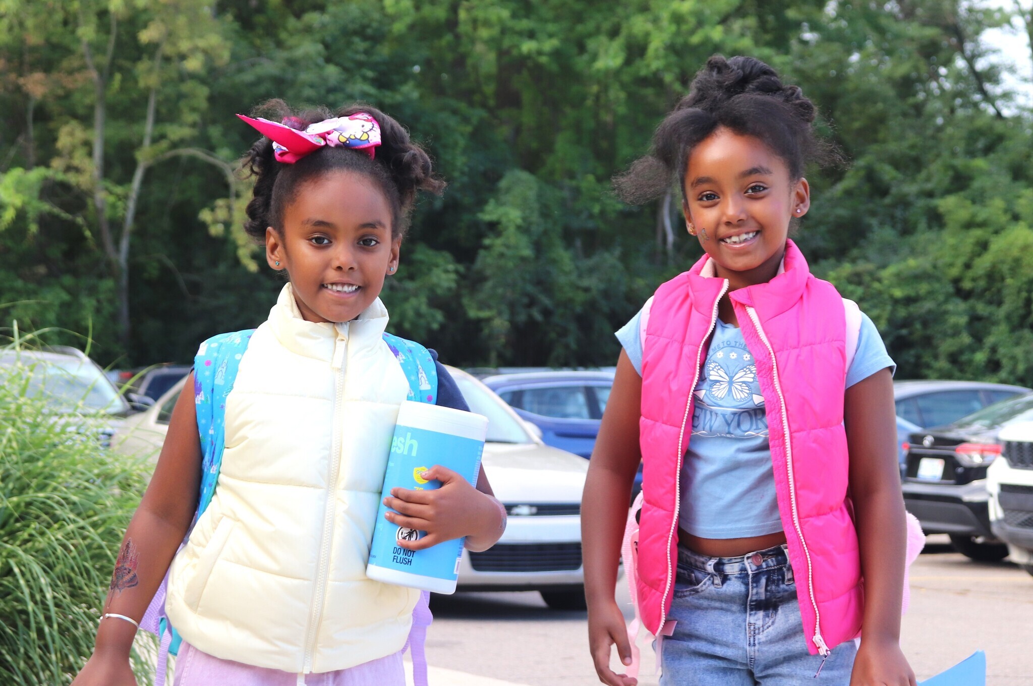 Two girls arriving to school
